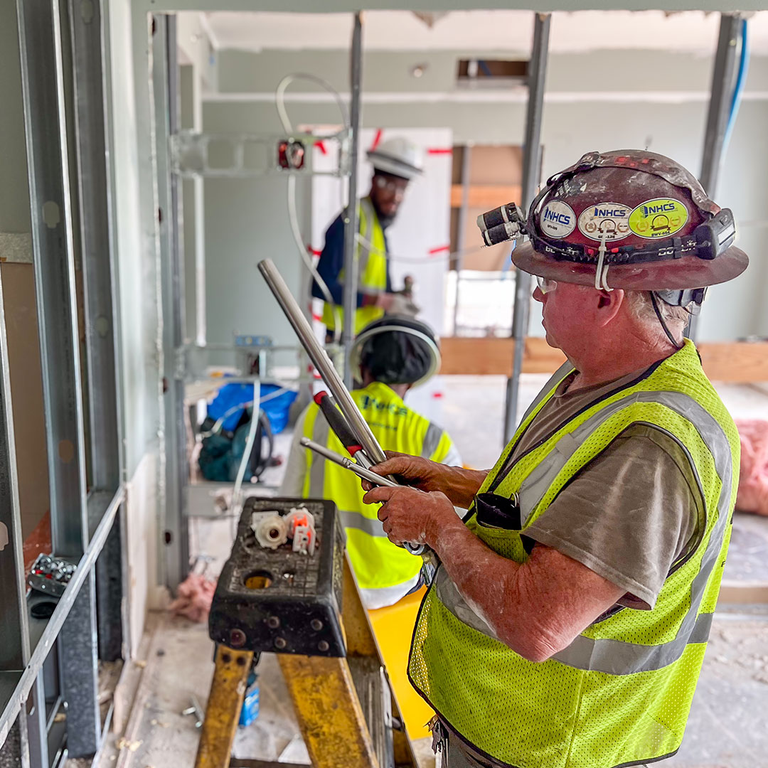 Skilled tradespeople working inside a commercial construction project
